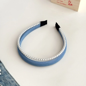 Close-up of blue denim pearl headband with white beads and comfortable end tips