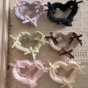 Pinces à cheveux élégantes avec nœuds et cœurs en six couleurs sur fond beige texturé