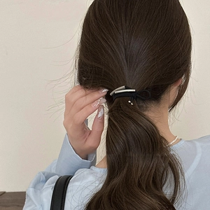 Rear view of high-elastic black hair tie with dual silver metallic curved tube accents