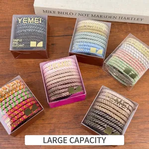 Set of colorful high-elasticity braided hair ties in clear packaging on a wooden surface