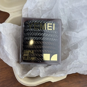 Detailed view of durable high-elastic woven hair bands in a branded clear display box