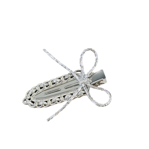 Barrette à cheveux argentée avec nœud scintillant et bordure en métal tressé
