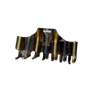 Large acetate shark hair claw clip with colorful vertical stripes and gold logo