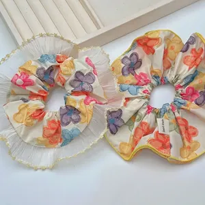 Floral scrunchies set in beige with orange and blue patterns and lace trim details