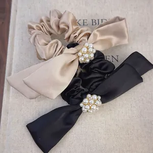 Elegant satin bow hair ties with pearl and rhinestone accents in black and champagne