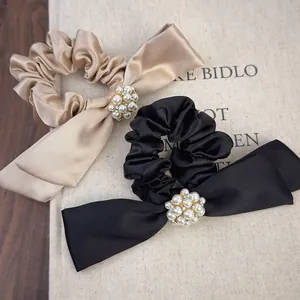 Elegant satin bow hair scrunchies with white pearls and rhinestones in champagne and black