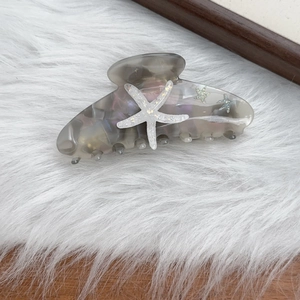Smoky grey marble acetate hair claw clip with white starfish and glitter star accents