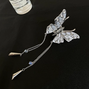 Detailed view of silver butterfly hair claw clip with rhinestones and long metal tassels