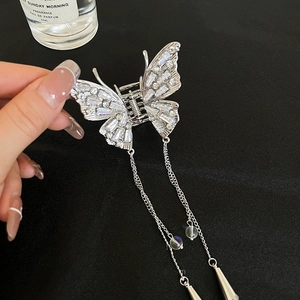 Silver butterfly hair claw with sparkling zircons and long elegant metal tassel chains