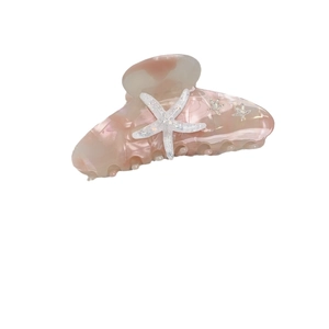 Starfish hair claw clip with pink marble acetate pattern and sparkling rhinestones