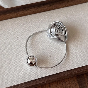 Detail of silver rose hair tie with polished metal bead on high-elastic elastic band
