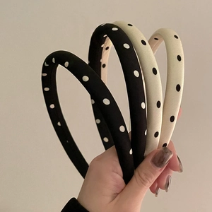 Polka dot satin headbands in black and cream featuring a padded sponge design