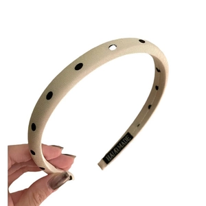 Beige polka dot satin headband with high-arch sponge padding and handmade label