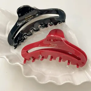 Barrettes à cheveux élégantes en acétate noir et rouge brillant avec écriture dorée