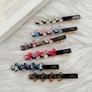 Set of six acetate flower hair clips with rhinestones and gold handmade lettering