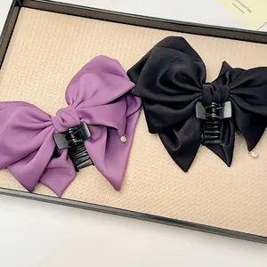 Elegant multi-layer satin bow hair claw clips in purple and black with rhinestone charm
