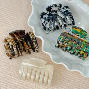 Minimalist acetate square hair claw clips in four colors with gold lettering on white tray