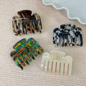Chic acetate square hair claws with gold lettering in marble and tortoise patterns
