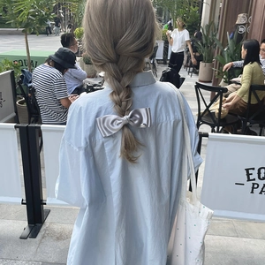 French style double-layer satin bow hair clip with silver label on braided hair
