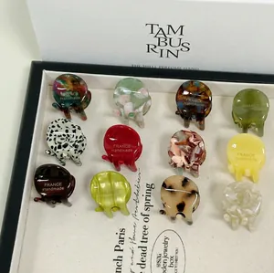 Set of 12 mini acetate hair claws with marble and tortoiseshell patterns in a gift box