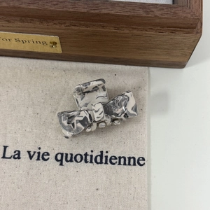 Elegant marble pattern acetate bow hair claw clip on canvas for chic French styling