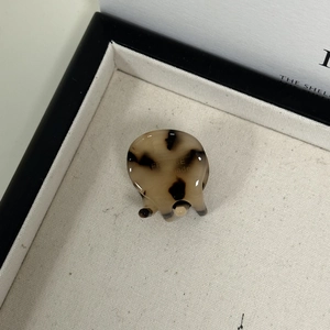 Detailed top view of a mini tortoiseshell hair claw clip with France handmade gold stamp