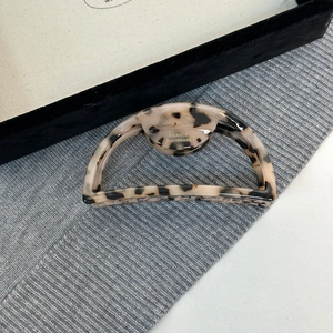 Close-up of tortoise shell acetate hair claw clip with golden France Handmade logo