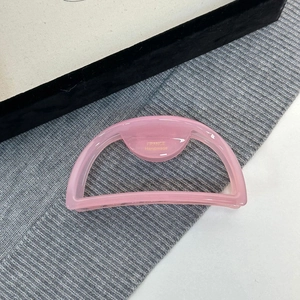 Detail of pink acetate hair claw clip featuring the golden FRANCE Handmade logo engraving