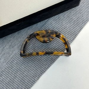 Macro shot of large tortoise shell hair claw with gold France Handmade logo detail