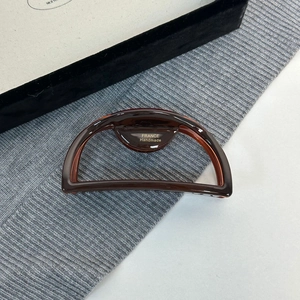 Detail view of the France Handmade gold stamp on a large tortoiseshell acetate hair claw