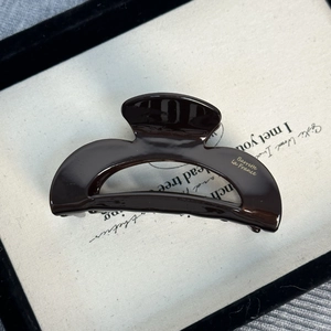 Détail d'une pince à cheveux marron chocolat avec lettrage doré Barrette La France