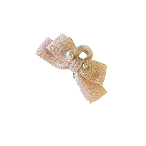 Pink tweed bow hair claw clip with white pearls and gold threads on white background