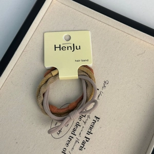 Close-up of high elasticity brown and purple hair ties with elegant ribbon bow detail