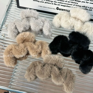 Furry wavy shark hair claws for women in five colors displayed on glass surface