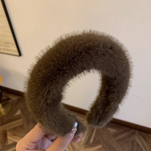Close-up of thick dark brown faux fur headband with fluffy texture for autumn winter style