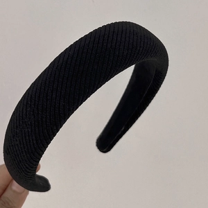 Close-up of black diagonal ribbed sponge headband with vintage high-top padded design