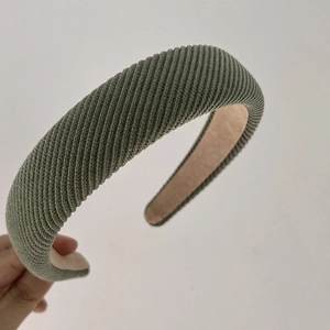 Close-up of military green vintage sponge headband with diagonal twill knit texture