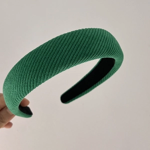 Detail shot of green sponge headband showing twill knit texture and anti-slip lining