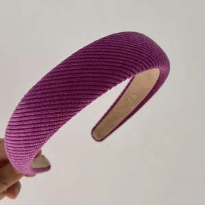 Detail view of purple knit sponge headband with textured fabric and non-slip lining