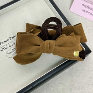 Maillard style dark brown suede bow hair claw clip with golden fashion logo charm