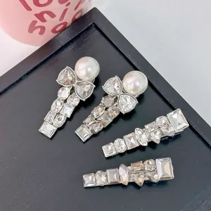 Sparkling rhinestone hair clip set with pearl butterfly design on silver alloy base