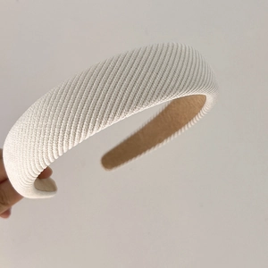 Detail view of cream white twill knit sponge headband with thick padded vintage texture