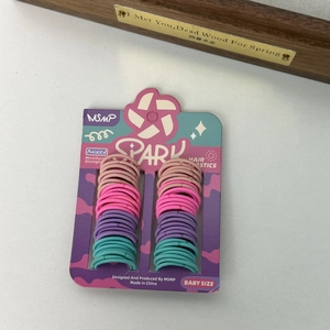 Detail of multi-colored high-elasticity baby hair ties set on a star-themed card
