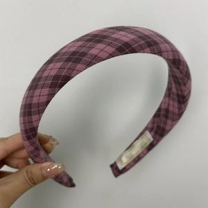 Detail of pink plaid sponge headband with thick fabric texture and nonslip lining