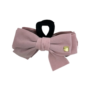 Elegant large suede bow shark hair claw clip in dusty pink with golden fashion tag