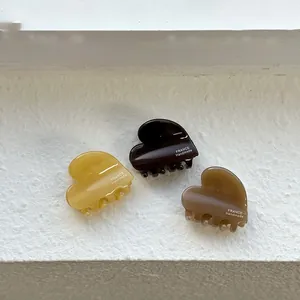 Trois pinces à cheveux cœur en acétate en ambre, café foncé et taupe, vue détaillée