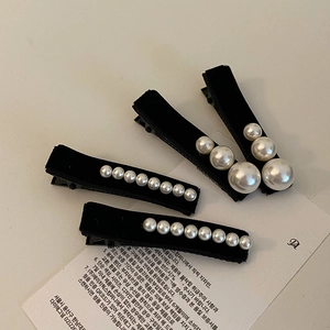 Elegant French velvet hair clips with pearls on a 45-degree angle display card