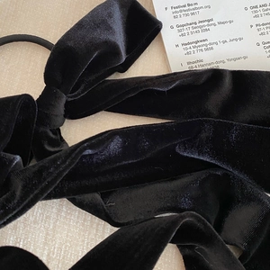French vintage black velvet bow hair scrunchie with long ribbons for a soft elegant style