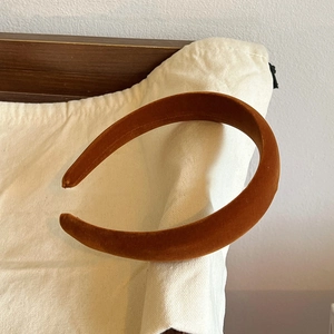Close-up of rust orange velvet padded headband with high-top sponge texture