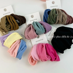 Set of soft elastic hair ties in multiple solid colors on white background for women